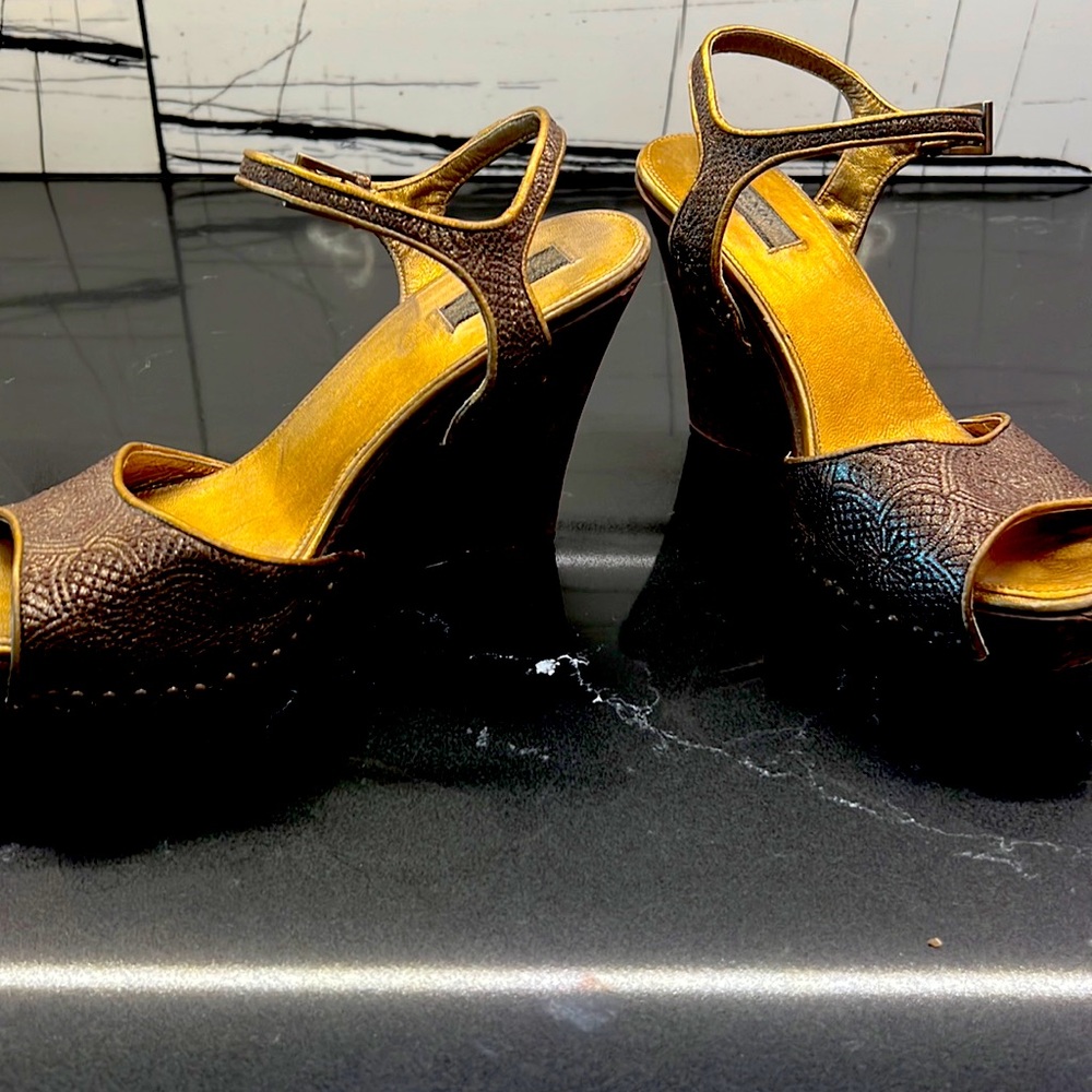 Prada dark gold textured platform wedges.